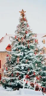 Snowy village with Christmas tree and decorations.