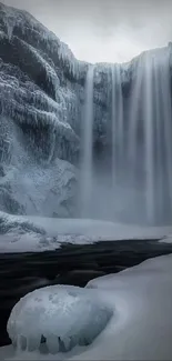 Winter waterfall with ice and snow in a serene natural landscape.