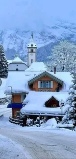 Alpine village in winter with snow-covered buildings and trees.