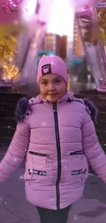 Child in a pink coat under winter lights.