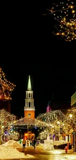 Snowy town square with festive lights at night.