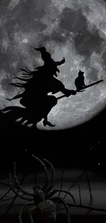 Silhouette of a witch flying on a broomstick in front of a full moon.