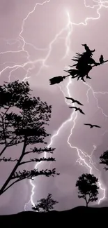 Silhouette of a witch flying through a stormy sky with lightning bolts.