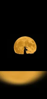 Silhouette of a witch under full yellow moon.