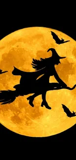 Witch silhouette flying across a golden full moon with bats.