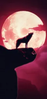 Silhouetted wolf against full moon with dark red sky.