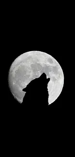 Silhouette of a wolf howling at a bright full moon.