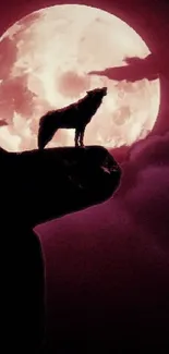 Wolf silhouette against a full moon with red and purple sky.