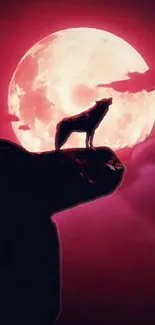 Silhouette of a wolf under a red moon sky, creating a dramatic night scene.