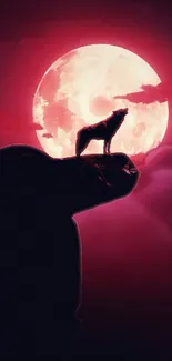 Silhouette of a wolf howling at a red moon.