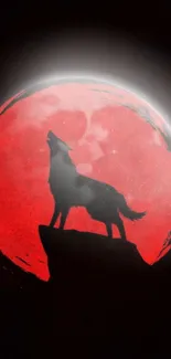 Wolf silhouette howling at red moon on a dark night.