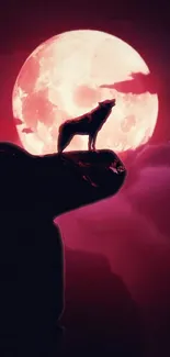 Wolf silhouette poised under a vibrant red moon.