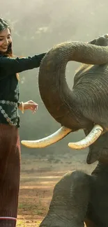 Woman joyfully interacts with elephant in serene setting.