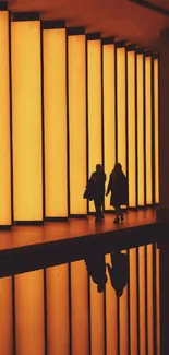 Silhouetted figures against orange backlit panels with reflective floor.