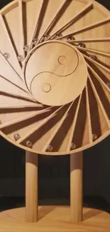 Wooden Yin Yang sculpture with spiral design.