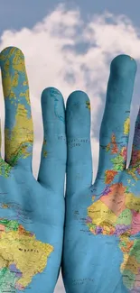 Hands painted with world map against a cloudy sky backdrop.