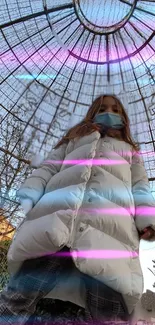 Person in a white coat under a neon-lit glass dome.