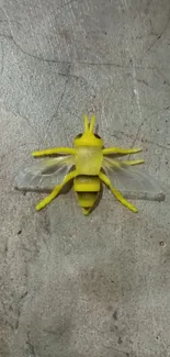 Yellow insect on gray concrete background, perfect for unique mobile wallpaper.