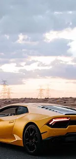 Yellow sports car driving on desert highway at sunset.