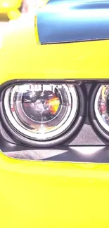 Close-up of a yellow car headlight with bright details.