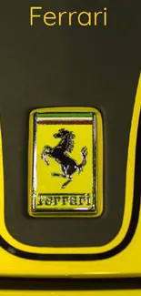 Yellow Ferrari emblem wallpaper with prancing horse logo.