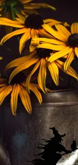 Yellow flowers in a metal vase with a witch silhouette.