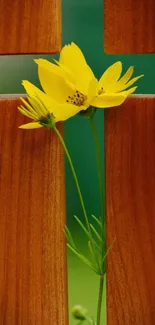 Yellow flowers against a carved wooden cross, creating a serene wallpaper.