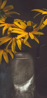 Yellow flowers in a vintage tin vase with dark background.