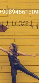 Woman holds umbrella against yellow background with love design.