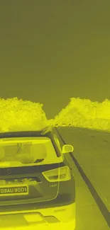 Yellow-tinted road with car on a scenic adventure.