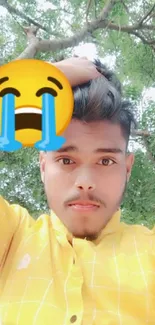 Selfie with yellow shirt and crying emoji in nature.