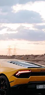 Yellow sports car on a scenic desert road.