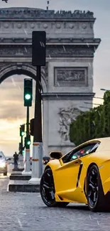 Yellow sports car near Arc de Triomphe at dusk.