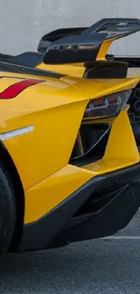 Yellow sports car parked on street with sleek design.