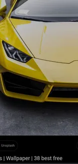 Yellow sports car with sleek design on concrete surface.