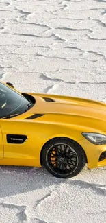 Yellow sports car on textured salt flat background.