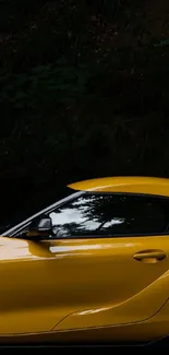 Sleek yellow sports car against dark backdrop for mobile wallpaper.