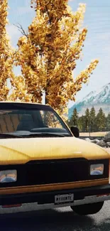 Yellow truck on autumn road with golden leaves and distant mountains.