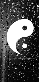 Yin Yang symbol with raindrops on black background.