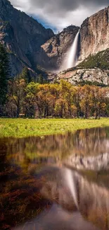Yosemite waterfall with lush greenery and reflective water.