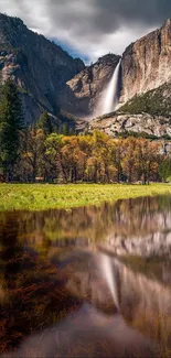 Breathtaking Yosemite waterfall reflected in serene waters with lush landscapes.