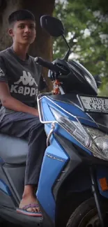 Young person on a blue scooter with green background.