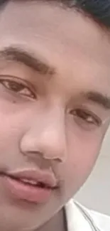 Close-up of a young individual with an expressive face for mobile wallpaper.