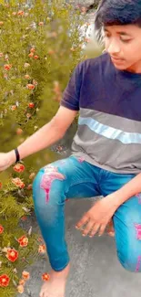 Young individual sitting near blooming flowers in a serene garden setting.