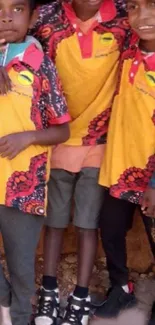 Three kids wearing vibrant, colorful clothing in a group setting.