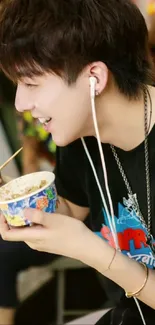 Smiling individual listening to music while enjoying a colorful bowl of food.