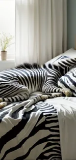 A cozy bedroom featuring a zebra print bedspread and soft natural light.