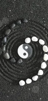 Yin yang stones on black background creating a serene, Zen-inspired mobile wallpaper.